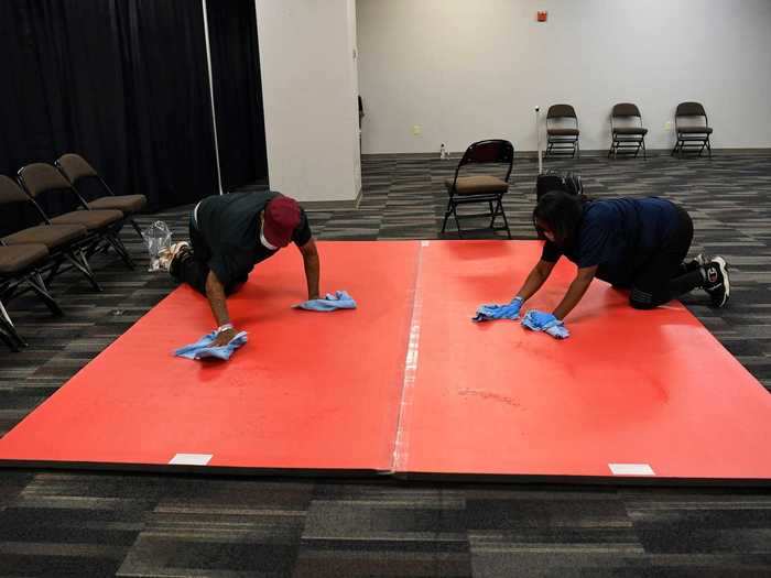 Staff sanitized warm-up mats. Athletes were kept in separate rooms while others isolated in the UFC host hotel, one mile away. When a fight finished, the athletes warming up entered the arena with the next competitors escorted from the hotel, to the venue.