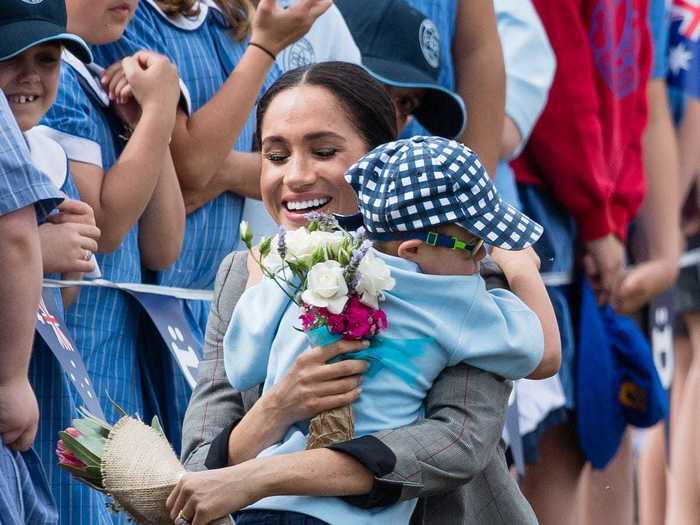 Although usually against royal protocol to do so, Markle and Harry were happy to hug children who came out to see them on tour.