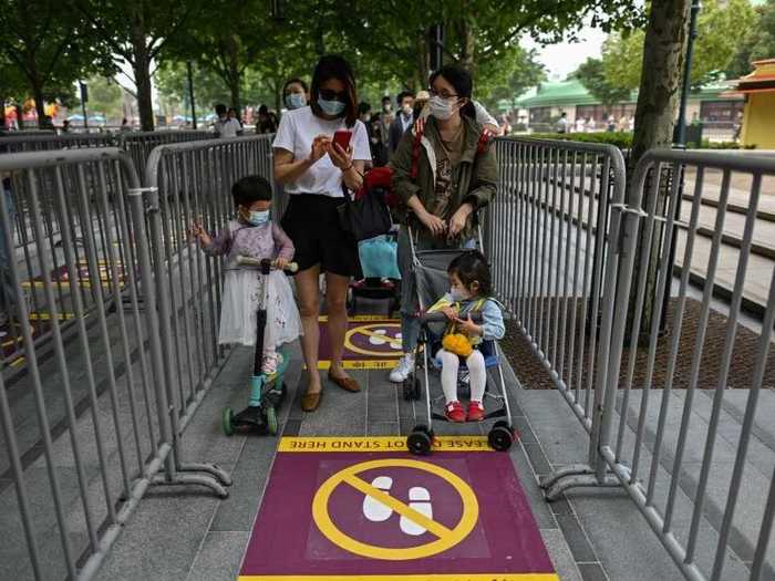 Now, yellow tape and signs on the ground mark the distance guests should keep from each other while waiting in line.