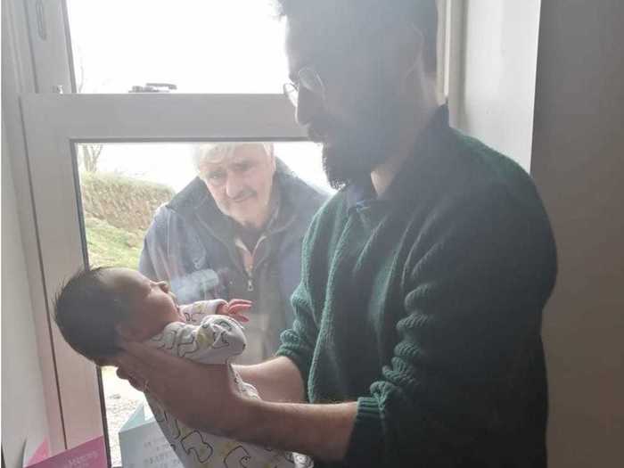 A grandfather met his grandson for the first time through a hospital window.