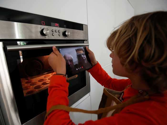 A child in Spain baked cookies with a little help from his grandparents via video chat.