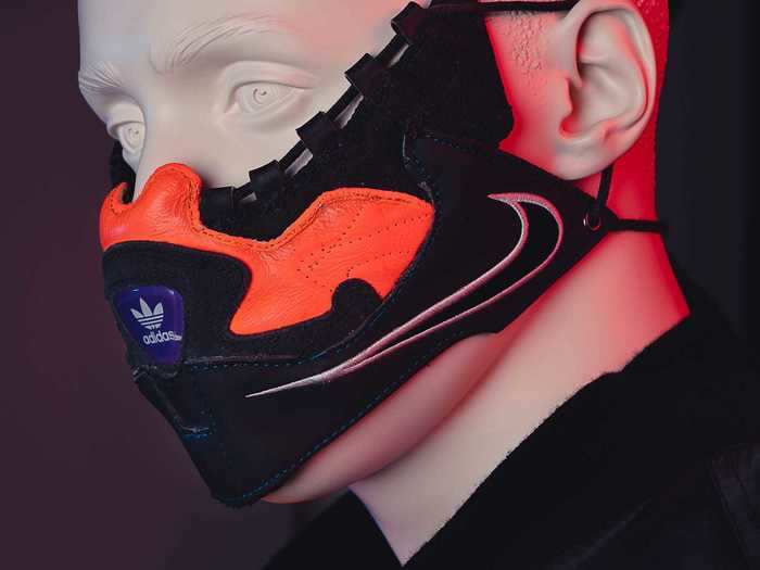 The mask features the Adidas logo on the front and pays homage to Nike with a large Swoosh on the side.