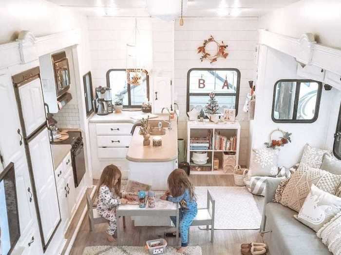 Opposite the couch, there is a wall of cabinetry for storage.