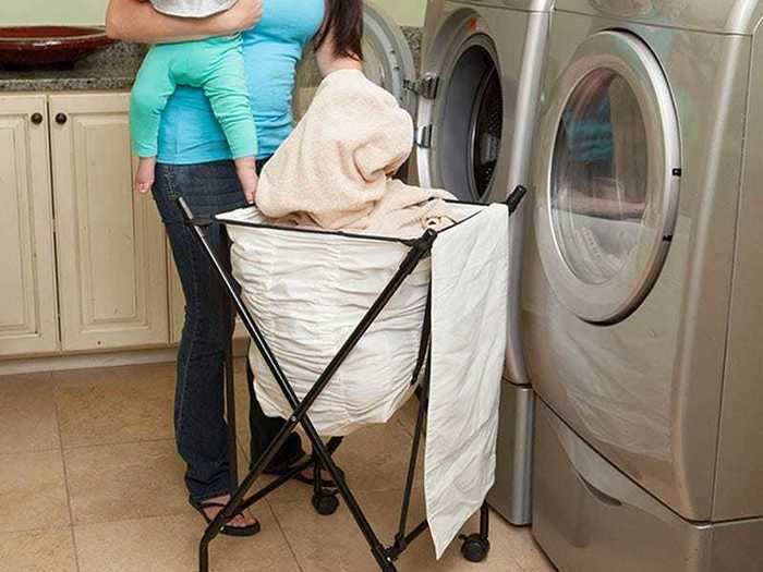 A spring-loaded laundry hamper