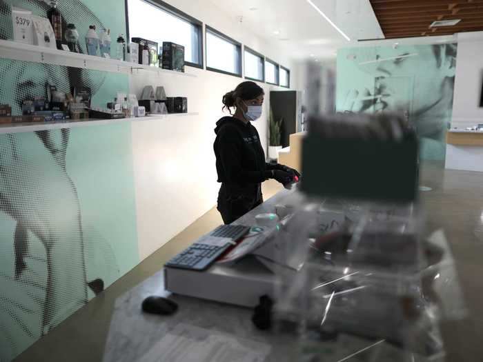 Ashlee Mason, 26, stands in an empty store at The Pottery Cannabis Dispensary, as marijuana deliveries increase amid the spread of the coronavirus disease (COVID-19).