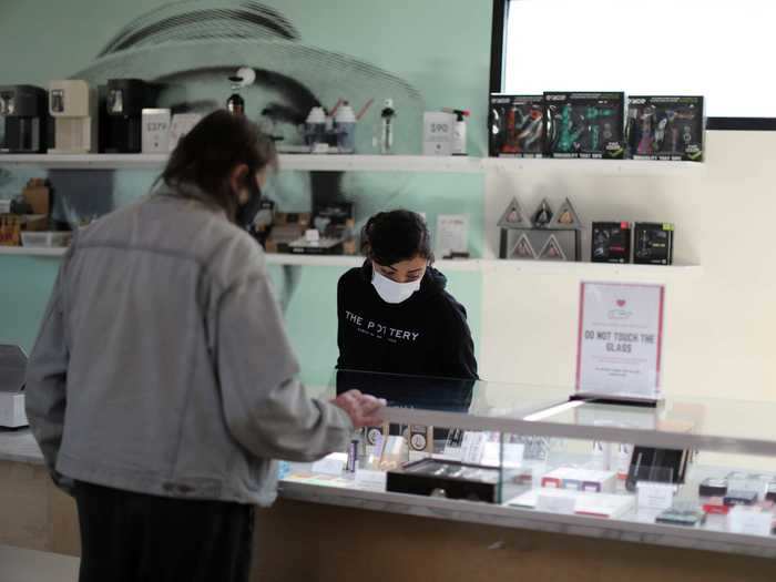 Customers and staff wear face masks and social distance inside the store.