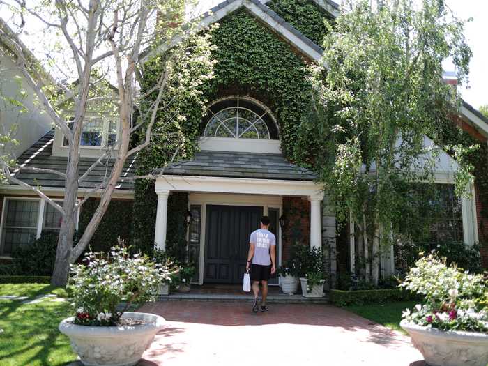 Brown delivers a bag for a customer in a wealthy neighborhood of Pacific Palisades, Los Angeles, California.