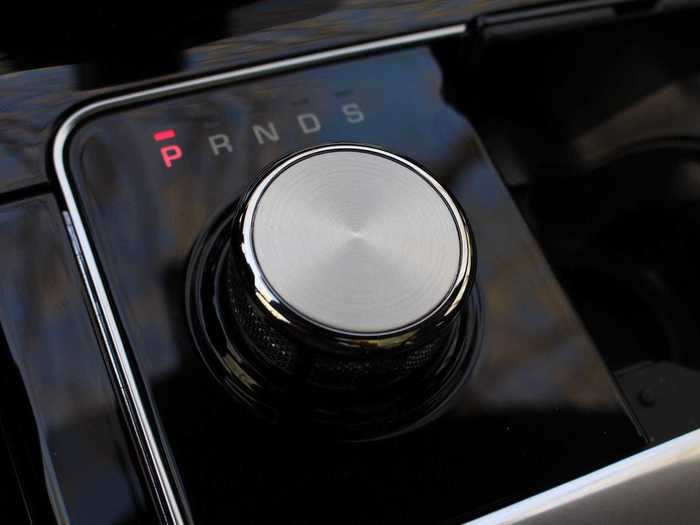 The gearshift knob rises from the center console — a small pool of piano black — when the engine is fired up. It