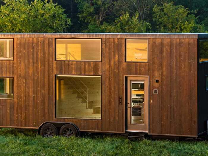 The tiny home has Japanese-inspired elements, such as burnt wood siding, which is known as "Shou Sugi Ban." This wood theme also extends to the pine wood-lined interior.