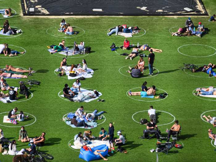 People practice social distancing in Domino Park in Williamsburg during the coronavirus pandemic on May 17, 2020 in New York City.