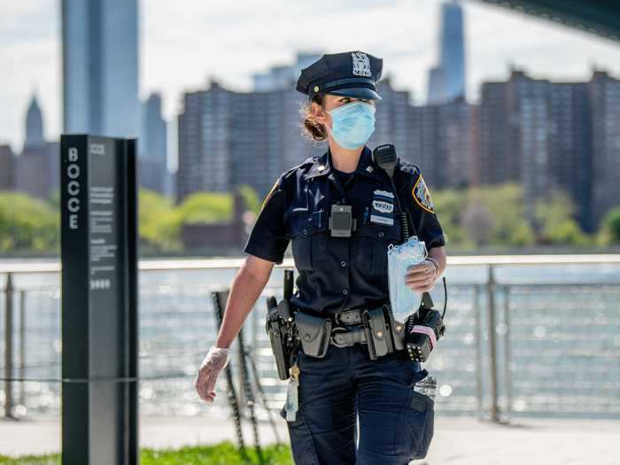 Police officers give out protective masks during the coronavirus pandemic. COVID-19 has spread to most countries around the world, claiming over 316,000 lives with over 4.8 million infections reported.