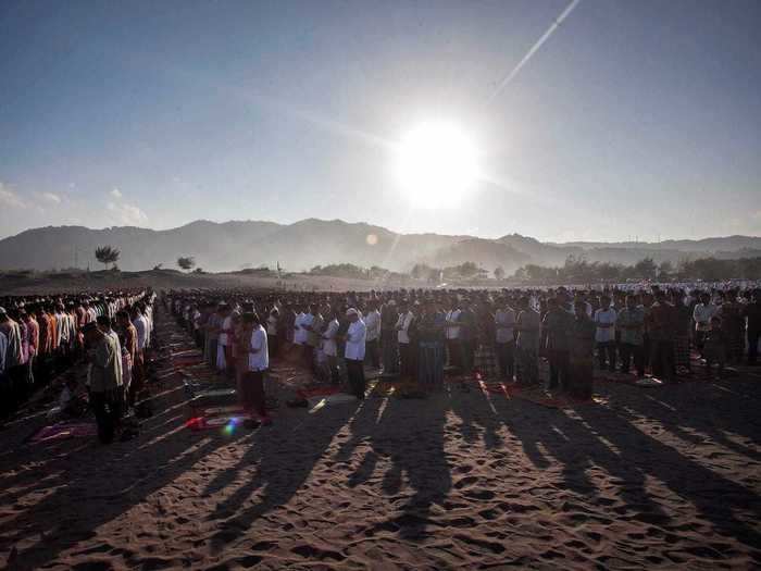 Crowds attend their morning prayer for Eid al-Fitr at Gumuk Pasir Parangkusumo, just south of Yogyakarta, Indonesia.