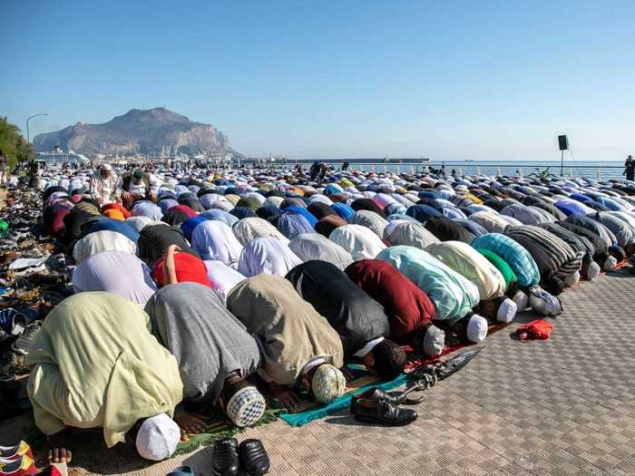 With Palermo, Italy, as the backdrop, a large gathering of Muslims come together to pray in 2019.