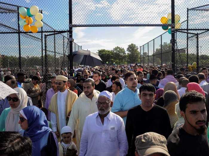 On the opposite coast, people join together at Bensonhurst Park in Brooklyn, New York, to take part in Eid al-Fitr prayers.