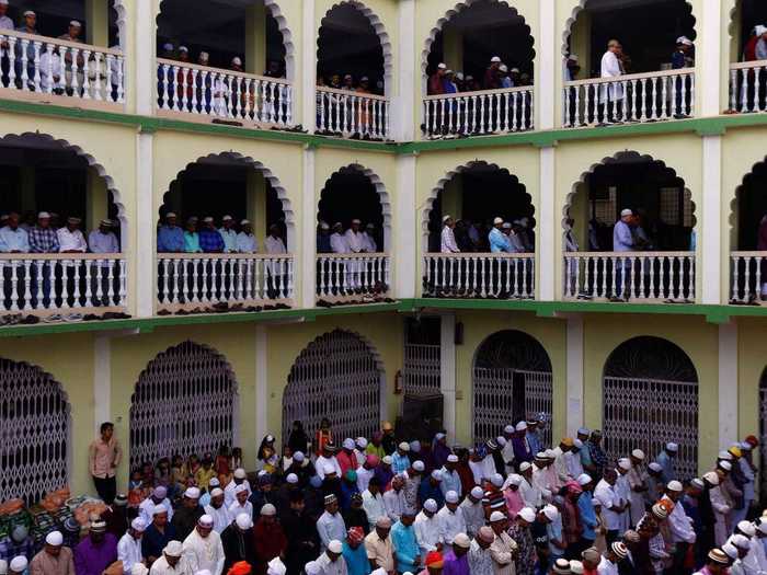 In Kathmandu, Nepal, Muslims gather together on multiple stories to pray together and celebrate the beginning of Eid al-Fitr.