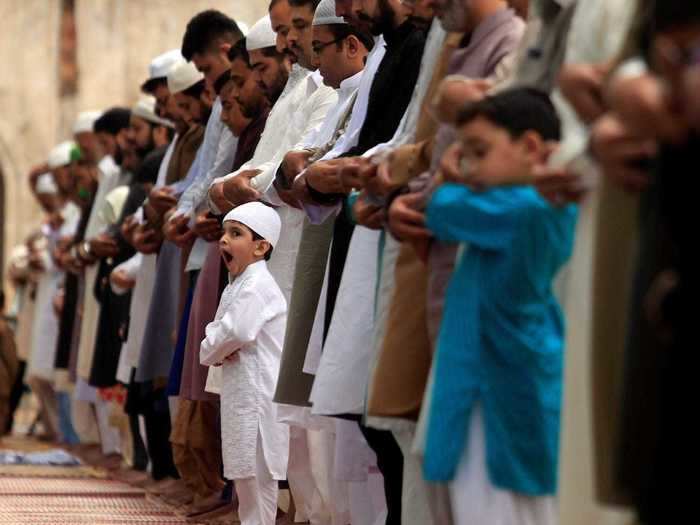 A sleepy boy starts his morning amongst others in Rawalpindi, Pakistan, to pray.