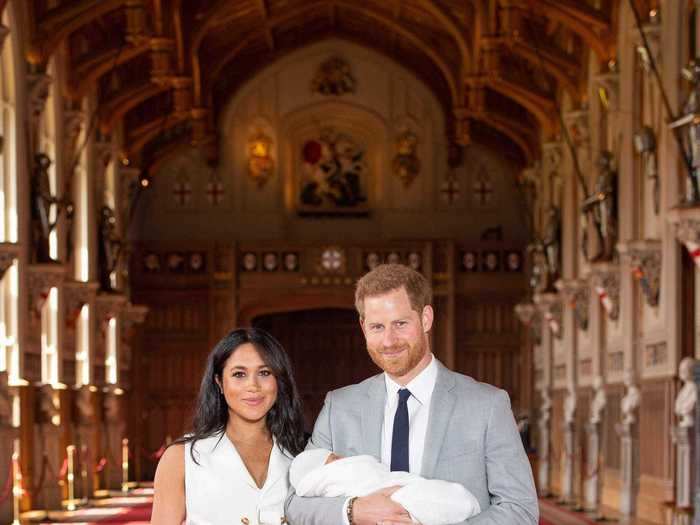 Markle wore a white tuxedo dress to pose for baby Archie