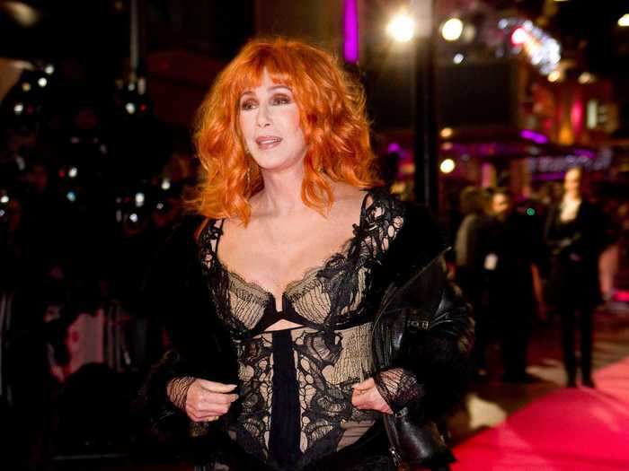 She continued her press tour for "Burlesque," rocking a lacey gown and orange hair in London.