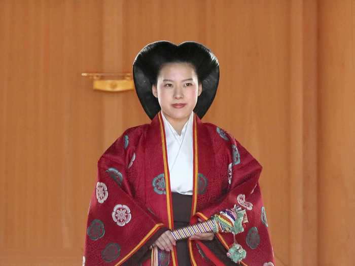 Ayako Moriya of Japan wore a red kouchiki — a cloak with long, wide sleeves — and a brown naga-bakama — a "divided skirt" — when she married shipping-firm employee Kei Moriya.