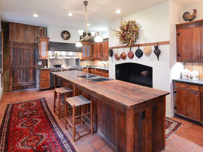 The kitchen features a large island and has windows overlooking the property