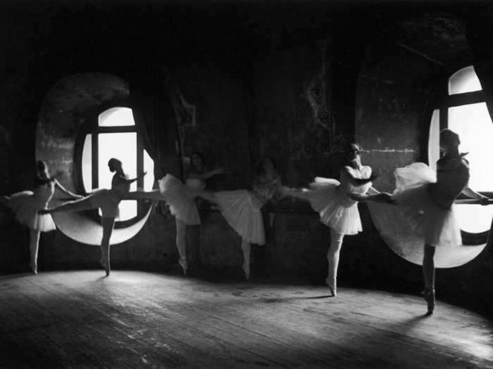 In this photo, ballerinas in the Parisian Grand Opera are photographed rehearsing in a Parisian dance studio in 1930.