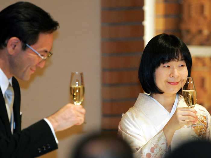 Yoshiki Kuroda and Sayako Kuroda of Japan raise glasses of Champagne in a toast at their 2005 nuptials.