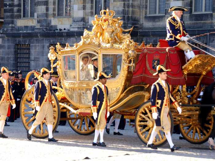 Prince Willem Alexander and Princess Maxima Zorreguieta of the Netherlands rode in a golden horse-drawn carriage after their wedding ceremony.