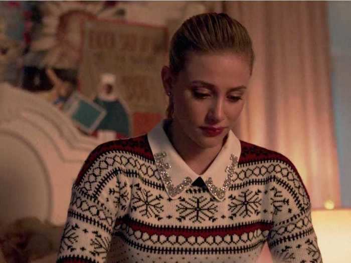 Betty styled her holiday sweater with an embellished collared shirt.