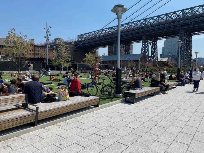 A mix of "quarantine fatigue" and restlessness from months indoors and rising temperatures have made it difficult to keep people from gathering outside. Domino Park in Brooklyn, New York was no exception.