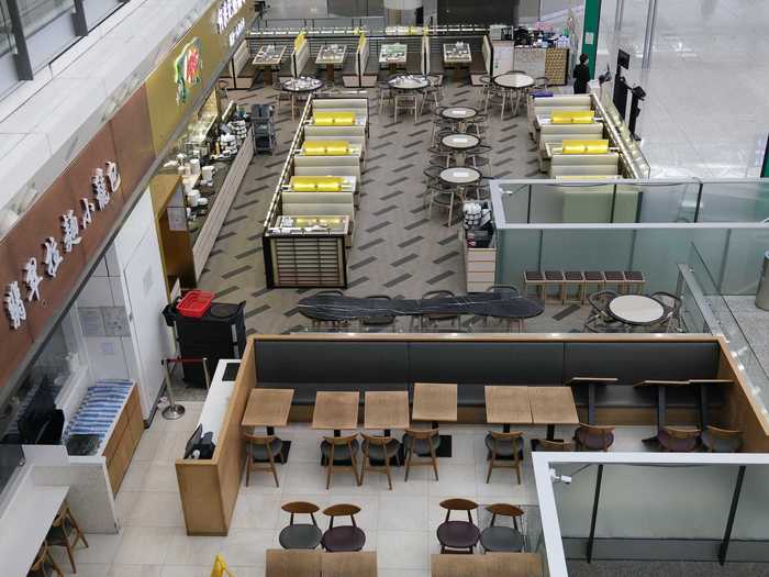 Airport restaurants have been left abandoned, as well. In this photo, dining areas at the Hong Kong International Airport are completely shuttered.