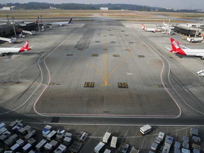 In Brazil, an empty runway is seen at the Guarulhos International Airport on May 19.