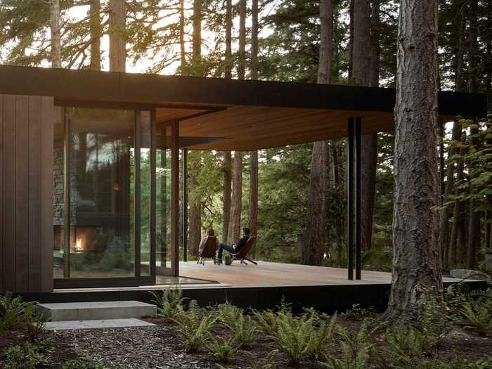 Pathways connecting the structures crisscross a courtyard filled with ferns and grasses ...