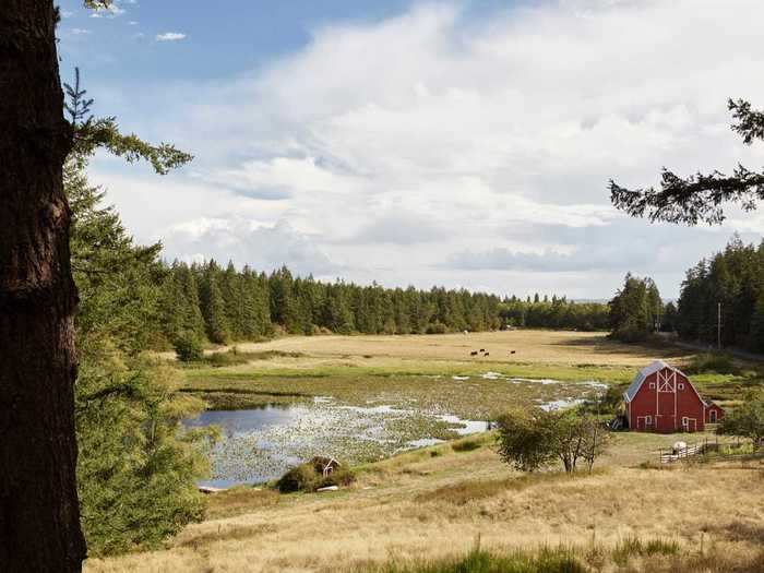 ... and features a turn-of-the-century red barn, cattle pastures, and a fish pond.