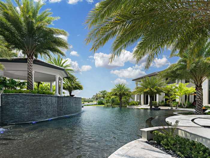 The property is surrounded by water. In addition to a swimming pool, it has an infinity pool, waterfalls, and a koi pond.