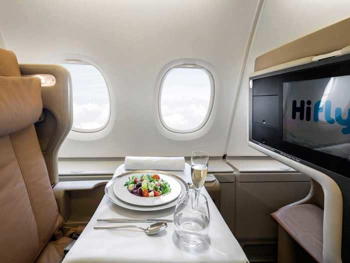 In-flight entertainment is provided via massive screens controllable by touch or remote.