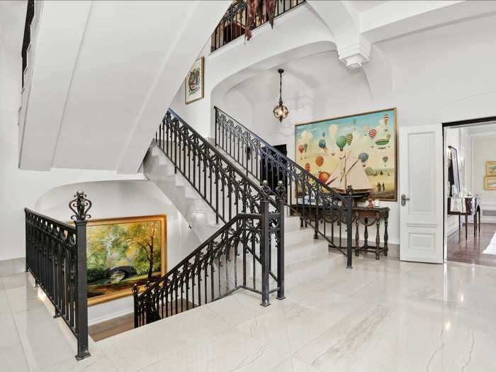 An art-decorated white marble staircase is one way to ascend to the castle