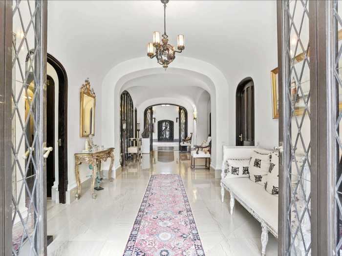 ... and chandelier-lined white marble hallway.