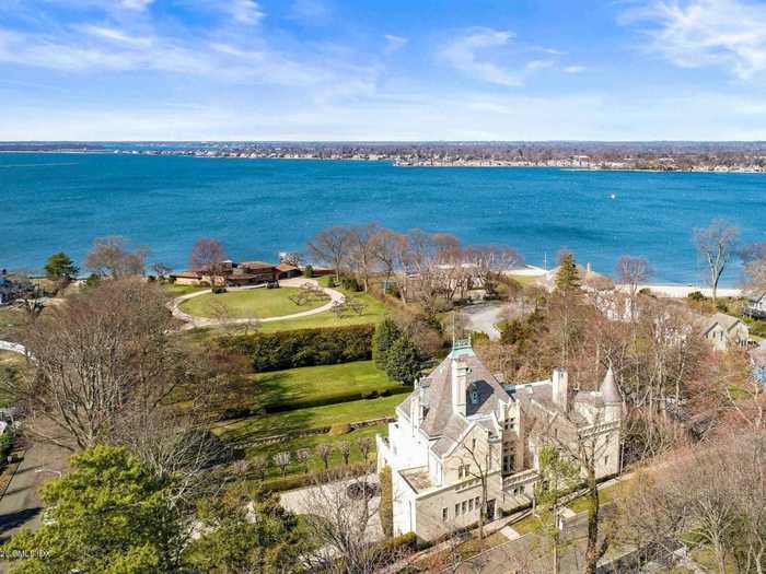 The home boasts sweeping views of Long Island Sound, comes with neighborhood beach access ...