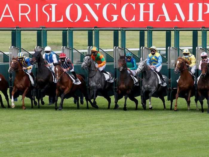 Jockeys now wear masks as horse racing resumes at Longchamp in Paris, France.