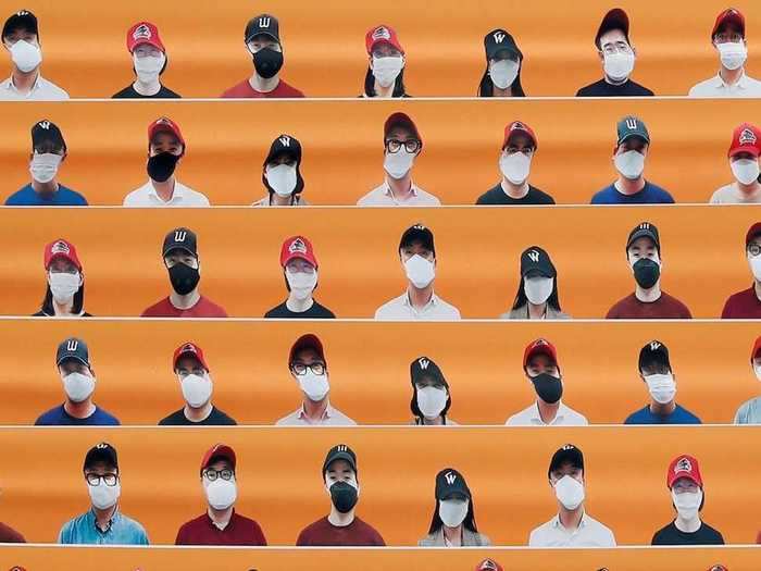 In a baseball stadium in South Korea, the makeshift fans wear masks.