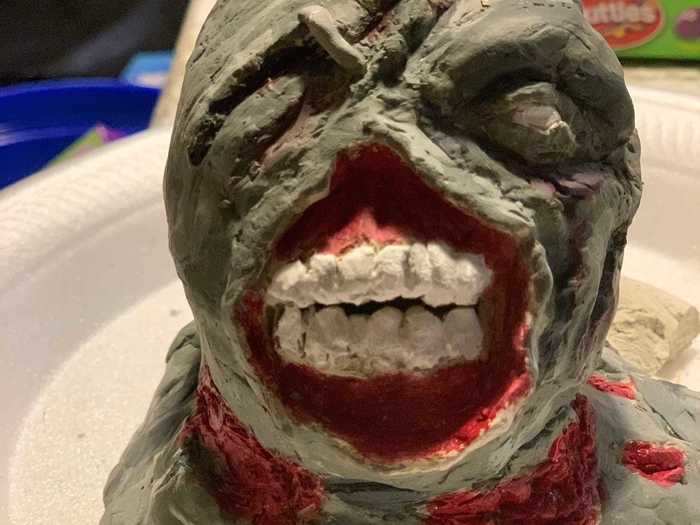 Using acrylic paint, I brought the zombie to life.