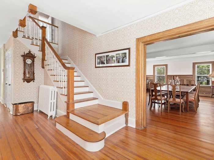 The interior is dominated by wood paneling, from the main staircase ...