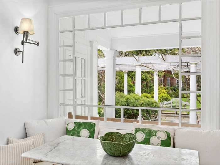 In addition to its wrap-around porch, the home has several distinctive features, like this light-filled breakfast nook ...
