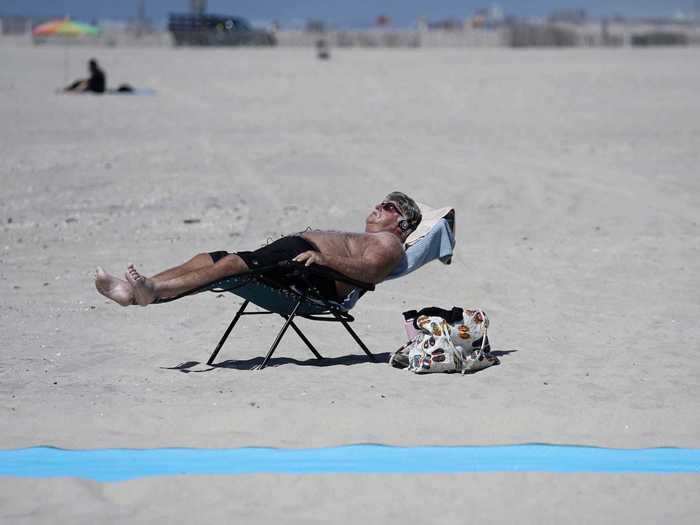 While some beaches are reopening, officials across the country are encouraging people to wear masks and social distance.