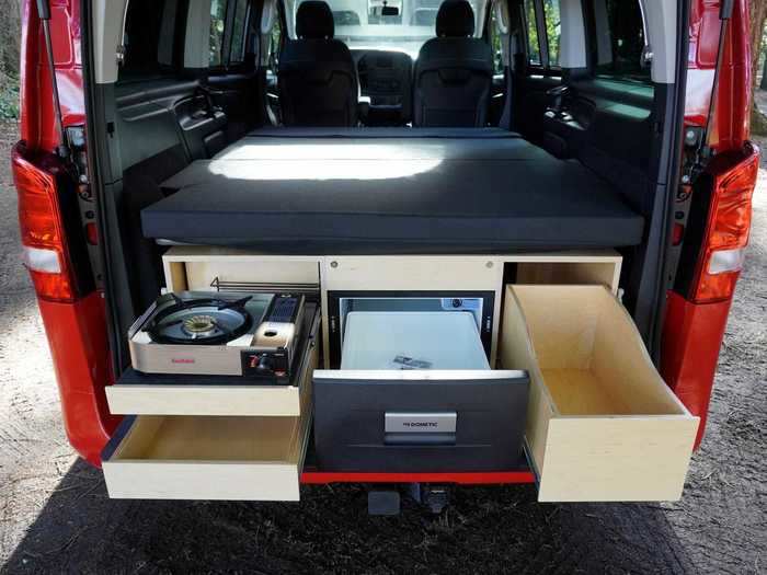 Caravan Outfitters decided on the kitchen box that extends out the back because it saves interior space and allows for full and easy access to both sliding doors of the van.