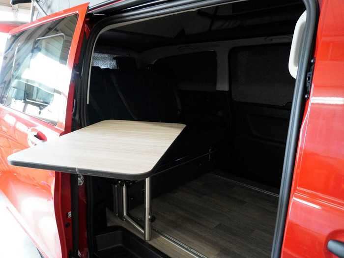 The table is able to swivel, allowing it to be used both inside and outside the tiny home on wheels.