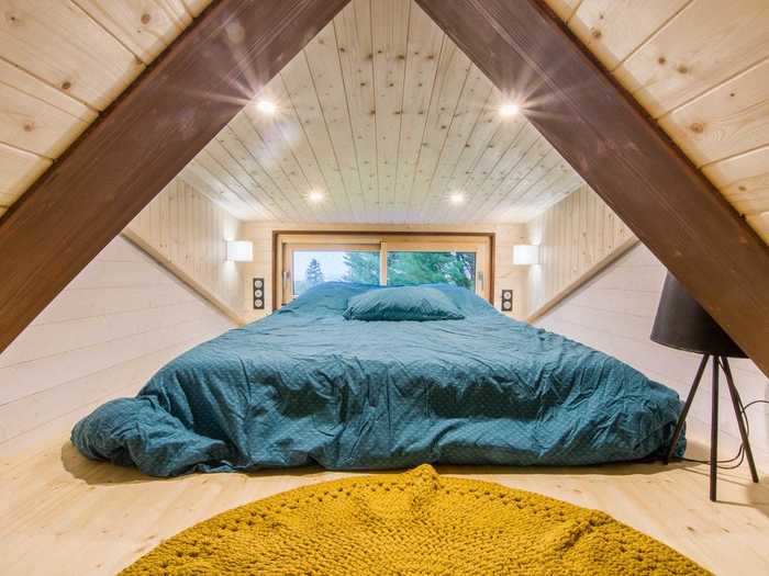 The upstairs of the lofted tiny home on wheels holds the bedroom, which can be accessed with the built-in ladder.