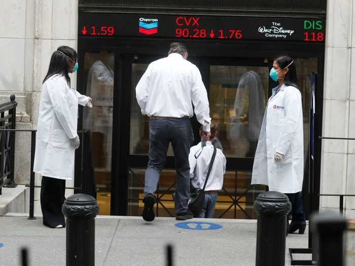 The New York Stock Exchange opened Tuesday the first time since March. Traders who enter the building must wear protective masks and receive fever screenings.