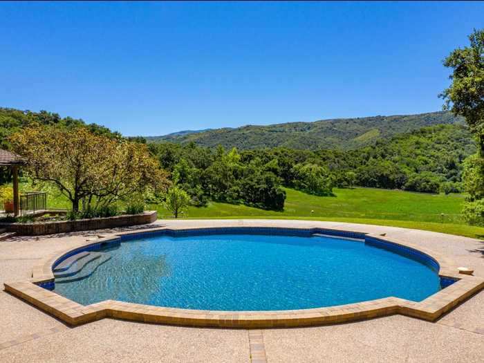 An outdoor swimming pool overlooks the ranch