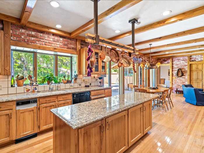 The kitchen has a large island and an adjoining dining nook.